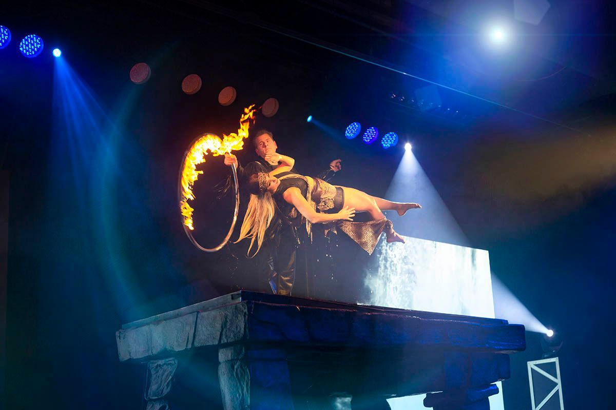 Greg Frewin performing a large-scale illusion on stage in Niagara Falls