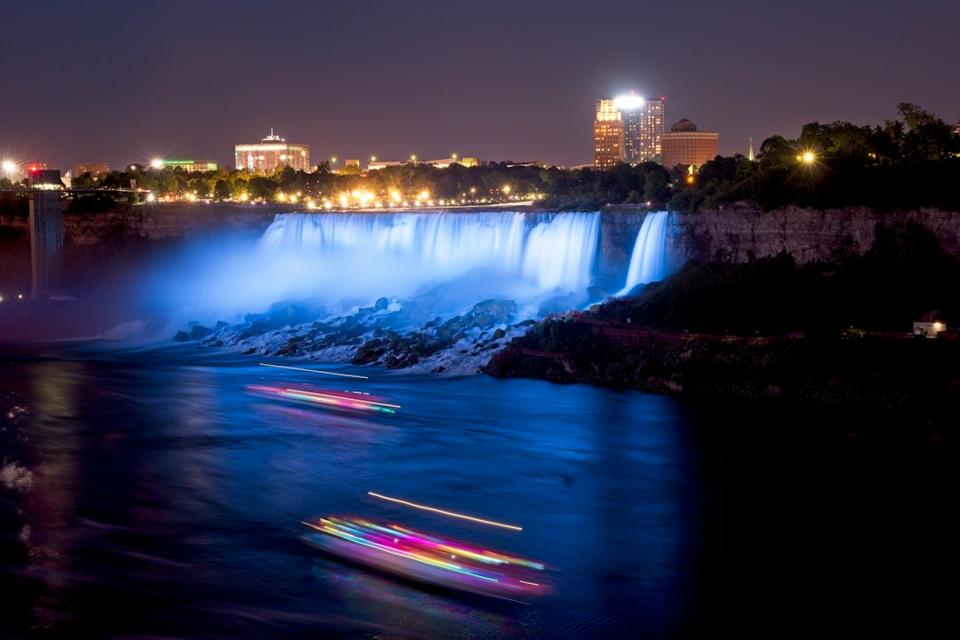American Falls and Bridal Veil Falls illuminated at night in Niagara Falls